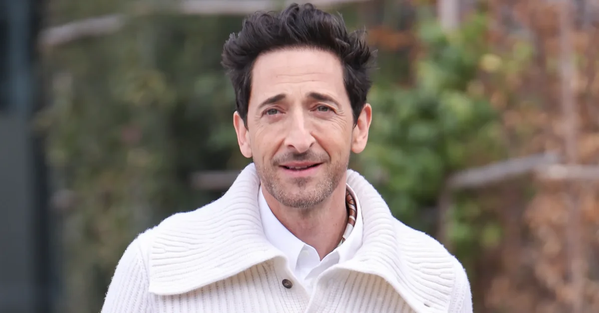 Adrien Brody posing confidently at a film premiere, showcasing his signature style and charisma as highlighted in the article introduction.