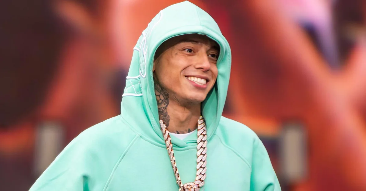 Central Cee British rapper in white jacket with calm expression on simple background