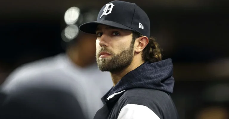 Daniel Norris standing near his 1978 Volkswagen Westfalia van — the MLB pitcher known for living minimally despite earning over $12 million in career earnings