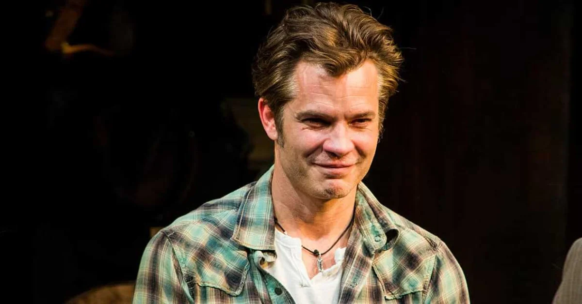 Henry Olyphant smiling outdoors in a casual outfit, son of actor Timothy Olyphant