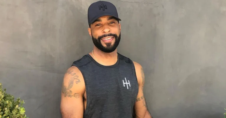 Jamil Hardwick smiling in dark jacket against plain background