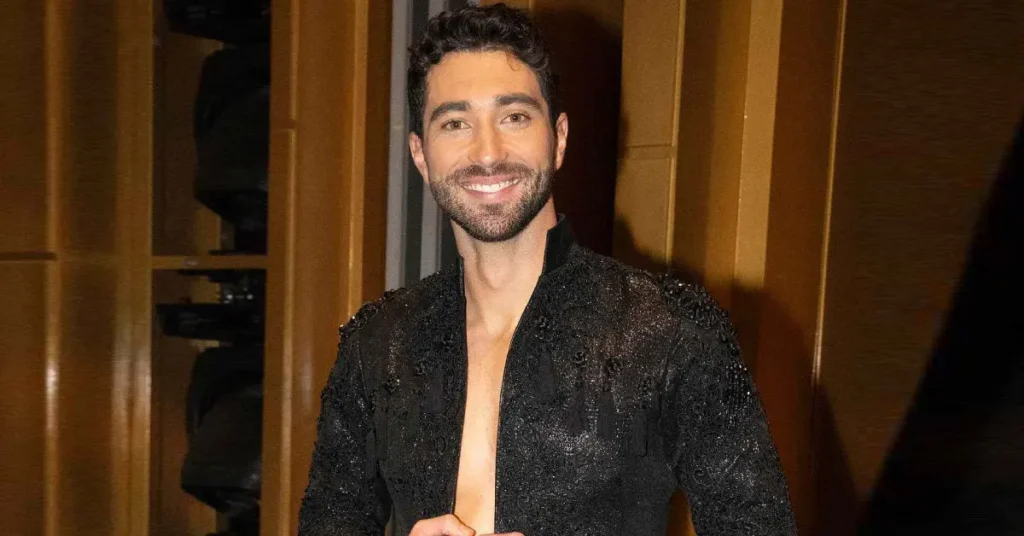 Joey Graziadei smiling in a casual jacket with a plain background