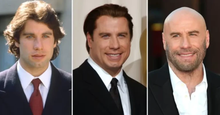 John Travolta smiling in a black suit with a bald head and blue background.