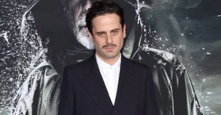 Luke Kirby smiling in a dark jacket, known for The Marvelous Mrs. Maisel