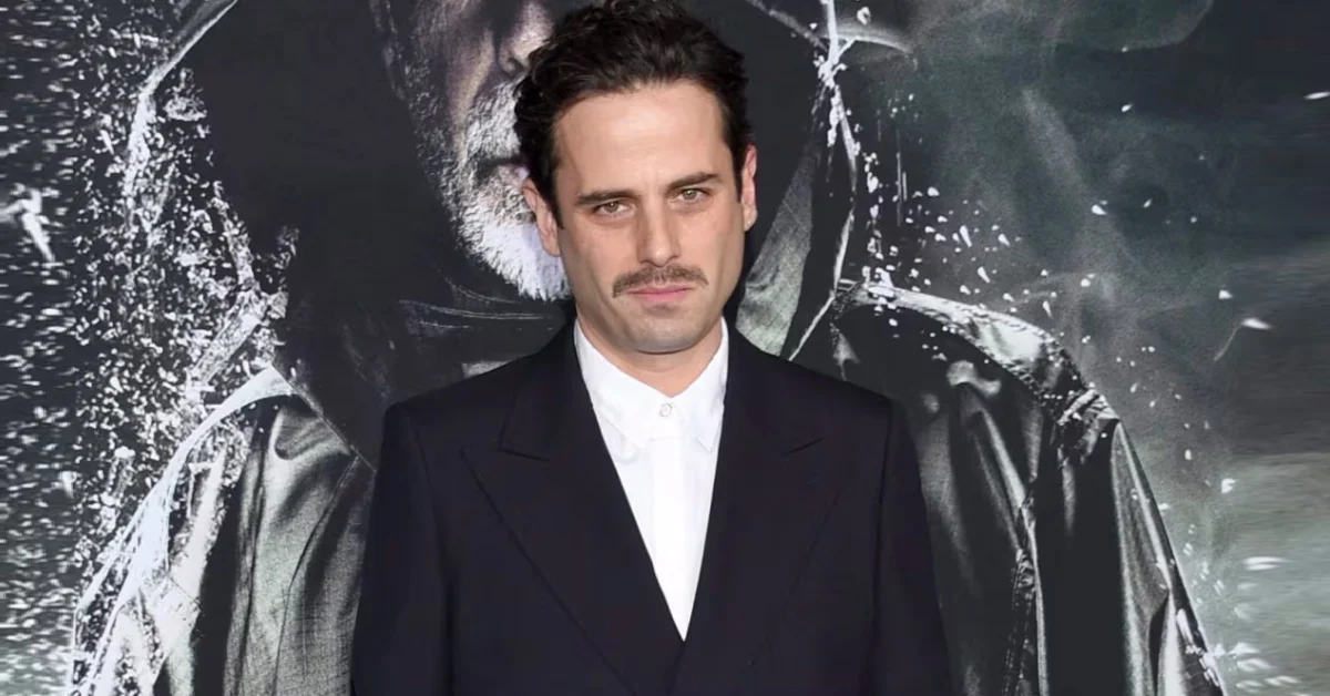 Luke Kirby smiling in a dark jacket, known for The Marvelous Mrs. Maisel