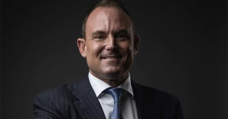 Patrick Carroll, Atlanta-based real estate entrepreneur and founder of CARROLL, standing at his Miami office — estimated net worth in tens of millions from building a $20.9 billion multifamily platform across the Sun Belt