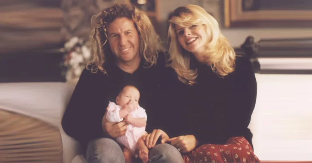 Betsy Berardi, ex-wife of Sammy Hagar, smiling in a black top and glasses.