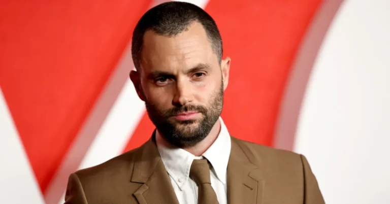 Penn Badgley smiling at an event, wearing a dark shirt – star of Netflix series You.