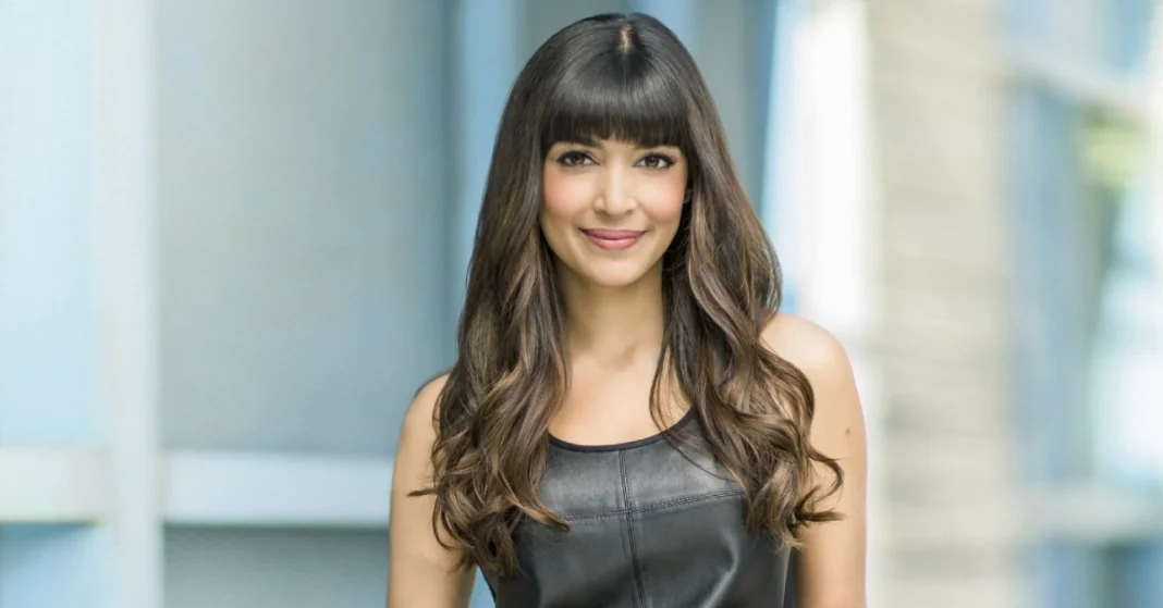Hannah Simone and her husband smiling together at a red carpet event, showcasing their strong bond and elegant style – perfect for a feature on Hannah Simone Husband.