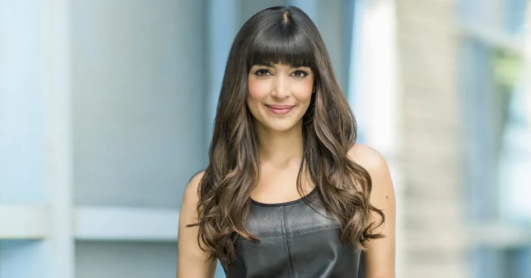 Hannah Simone and her husband smiling together at a red carpet event, showcasing their strong bond and elegant style – perfect for a feature on Hannah Simone Husband.