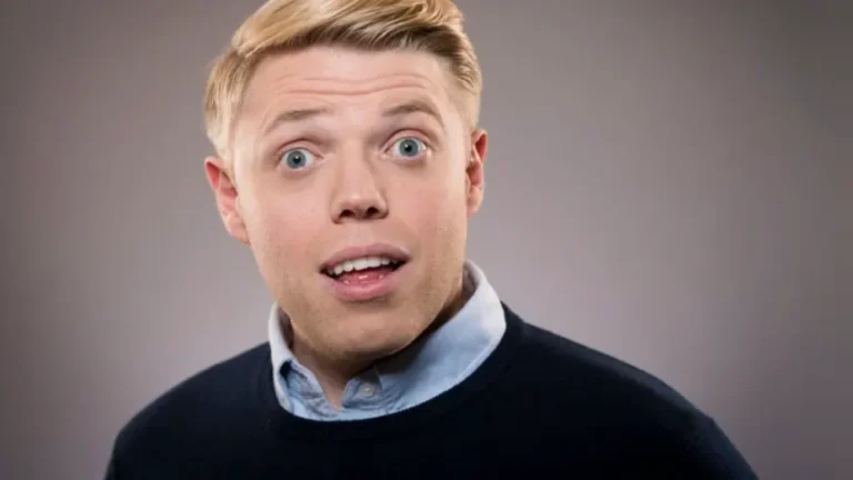 Rob Beckett sitting with wife Lou Beckett, reflecting on the comedian's £6 million estimated net worth built through stand-up, television, and podcasting