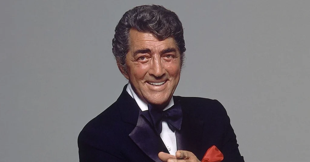Black-and-white portrait of Dean Martin smiling in a classic suit, reflecting his timeless charm as a legendary singer, actor, and Rat Pack icon.