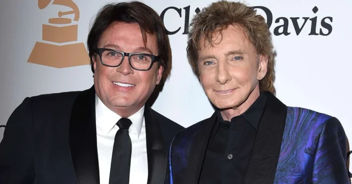 Garry Kief standing beside Barry Manilow at a public event, reflecting his role as both partner and manager in the music industry.