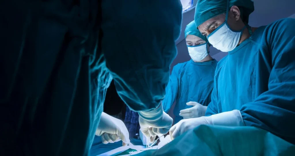 Injured Florida worker meeting with a doctor to discuss surgery and a workers’ comp claim.